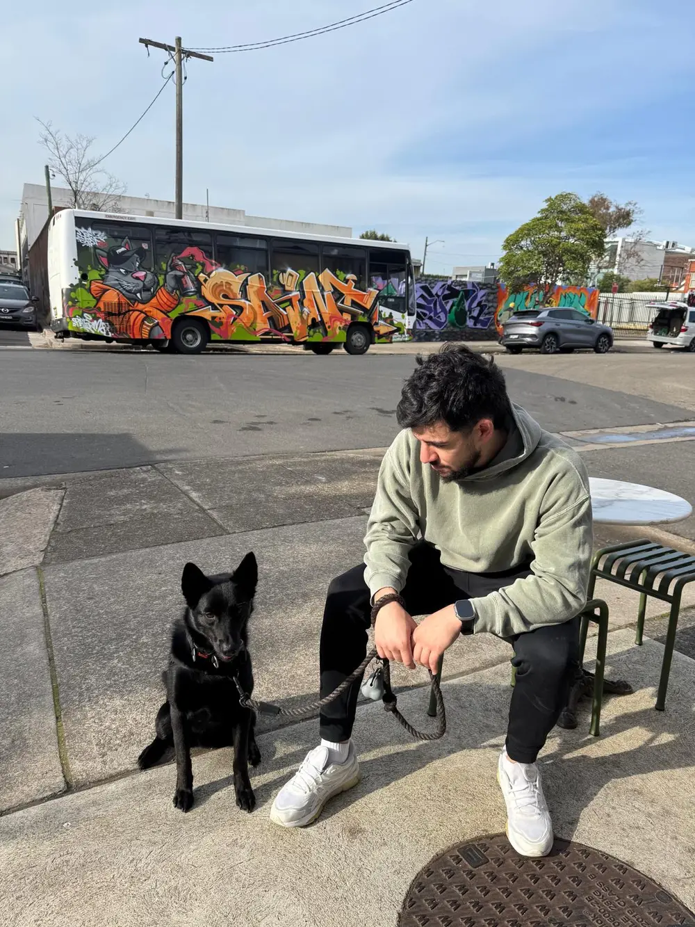 Josh from Kelpie Digital with his black kelpie, on an inner west street